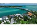 An aerial view shows waterfront homes, a bridge, and boats dotting the pristine turquoise water at 1435 Westway Dr, Sarasota, FL 34236