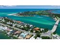 Panoramic aerial view showcases the waterfront homes and beautiful turquoise water along the coast at 1435 Westway Dr, Sarasota, FL 34236