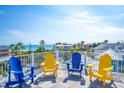 Rooftop deck with colorful Adirondack chairs offers panoramic ocean views and comfortable outdoor living at 205 17Th N St, Bradenton Beach, FL 34217
