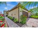 Beautiful home exterior with manicured landscaping and brick paver walkway leading to the garage at 213 Babbling Brook Run, Bradenton, FL 34212