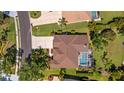 Aerial view of home featuring well-manicured landscaping, driveway, and screened pool at 3816 Little Country Rd, Parrish, FL 34219