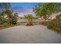 Beautifully designed two-story home with a spacious driveway and a cozy front porch at 4818 Givens Ct, Sarasota, FL 34242