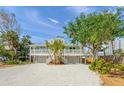 Attractive two-story home features a welcoming front porch and lush landscaping at 4818 Givens Ct, Sarasota, FL 34242