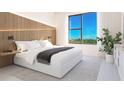 Bright bedroom with a large window and stylish décor with a wood panel accent wall at 4950 Remington Dr # 304, Sarasota, FL 34234