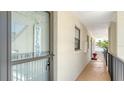 Welcoming entryway features neutral walls, a welcome sign and a view of the balcony at 525 Barcelona Ave # 207, Venice, FL 34285