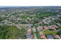 A neighborhood aerial view showcasing mature landscaping, a community layout, and nearby roads at 5355 Anthony Ln, Sarasota, FL 34233