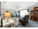 Inviting living room with comfortable seating, TV, and beautiful decor at 5521 Riverbluff Cir # V-10, Sarasota, FL 34231