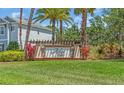 Arbor Lakes community sign with lush green lawn and colorful landscaping at 5740 Sunflower Cir, Sarasota, FL 34238