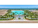 Aerial view of Aqua community amenities, showcasing the lagoon, beach, and landscaping at 5939 Redbay Blvd, Bradenton, FL 34210
