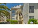 Charming condo exterior with wooden stairs and lush landscaping, offering a welcoming entrance and curb appeal at 6157 Midnight Pass Rd # B42, Sarasota, FL 34242