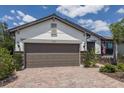 Charming one-story home with stone accents, two car garage, and meticulously maintained landscaping at 6713 Chester Trl, Bradenton, FL 34202