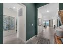 Inviting hallway with beige tile flooring, leading to a living area with a lake view and neutral décor at 8134 Shore Lake Dr, Englewood, FL 34224