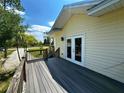 Spacious wooden deck with railing, offering a great outdoor area with double doors leading inside at 8297 Strasse Blvd, Punta Gorda, FL 33982