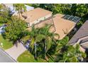 Aerial view of the home showcasing the tile roof, lanai, and mature landscaping at 9120 Willow Brook Dr, Sarasota, FL 34238