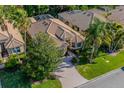 Aerial view of the home showcasing the tile roof, screened in lanai, and mature landscaping at 9120 Willow Brook Dr, Sarasota, FL 34238