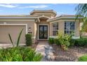 Inviting home exterior with a brick walkway leading to the front door and a well-manicured garden at 9120 Willow Brook Dr, Sarasota, FL 34238
