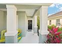 Inviting entryway featuring decorative columns and chairs providing a welcoming entrance at 12676 Sagewood Dr, Venice, FL 34293