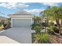 Charming single-story home featuring a two-car garage, and tropical landscaping at 12676 Sagewood Dr, Venice, FL 34293