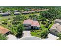 Aerial view of home and its surroundings, showcasing landscaping, tile roof, and convenient community access at 12838 Daisy Pl, Bradenton, FL 34212