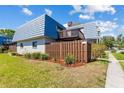 Charming townhome featuring a unique roofline, second story balcony, and well-maintained landscaping at 14519 Catalina Cir, Seminole, FL 33776