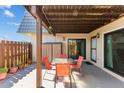 Relaxing outdoor patio with table, chairs, privacy fence, and convenient access to the interior at 14519 Catalina Cir, Seminole, FL 33776