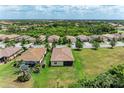 An aerial view showing the neighborhood with lush trees and greenery surrounding the properties at 157 Wandering Wetlands Cir, Bradenton, FL 34212