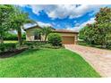 Charming home with lush landscaping, brick driveway, and a two-car garage, perfect for any Gathering at 157 Wandering Wetlands Cir, Bradenton, FL 34212