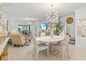 Open-concept living space with elegant decor, a dining area, and seamless access to outdoor living at 17576 Holly Well Ave, Wimauma, FL 33598