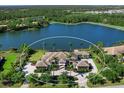 Aerial view of a luxury estate with beautiful landscaping and lake view at 18826 Ganton Ave, Lakewood Ranch, FL 34202