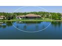 Aerial view of the rear exterior with lake view and screened in patio at 18826 Ganton Ave, Lakewood Ranch, FL 34202