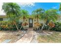 Attractive front entrance featuring a brick walkway, tropical plants, and a welcoming front door at 2908 Mayflower St, Sarasota, FL 34231