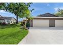 Attractive home with a two-car garage, tidy lawn and landscaping, showcasing curb appeal at 314 Oak Hill Way # 24, Sarasota, FL 34232