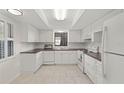 Bright kitchen featuring white cabinets, countertops, and appliances with tile flooring at 314 Oak Hill Way # 24, Sarasota, FL 34232