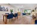 Open-concept living and dining area with stylish furnishings and wood flooring at 3360 Tallywood Ct # 7082, Sarasota, FL 34237