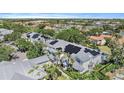 Beautiful aerial view of the home with solar panels and lush landscaping in a well-maintained community at 3405 54Th W Dr # 102, Bradenton, FL 34210