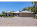 Beautiful home featuring a brick driveway, seahorse window accents, and a convenient two-car garage at 3931 Bay Shore Rd, Sarasota, FL 34234