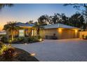 Charming home featuring a brick driveway, seahorse window accents, and a convenient two-car garage at 3931 Bay Shore Rd, Sarasota, FL 34234