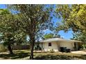 Back of a single-story home with a fenced in yard, a two-car garage, and a well-maintained lawn at 4170 Prudence Dr, Sarasota, FL 34235