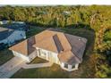 A bird's eye view of a well-maintained single Gathering home surrounded by lush greenery and neighboring houses at 4456 Callaway St, Port Charlotte, FL 33981