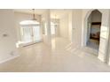 Bright open-plan living area with tile flooring, lots of natural light, and neutral walls ready for personalized decor at 4456 Callaway St, Port Charlotte, FL 33981
