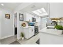 Modern kitchen featuring white cabinets, quartz countertops, and stainless steel appliances, designed for culinary enthusiasts at 4741 Watkins Ave, Sarasota, FL 34233