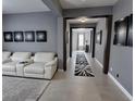 Bright hallway featuring decorative monochrome art, tiled floors and access to other rooms at 4970 Oyster Pearl St, Lakewood Ranch, FL 34211