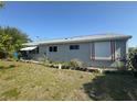 The back exterior of a single Gathering home with an awning over the back porch at 5315 Malamin Rd, North Port, FL 34287