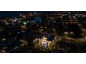 Aerial night view of home's pool and neighborhood near a canal, showcasing location and property features at 540 S Polk Dr, Sarasota, FL 34236