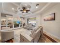 Bright living room featuring a coffered ceiling, a large flat-screen TV, and comfortable seating at 5624 Aaron Ct, Sarasota, FL 34232