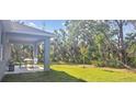 Lush backyard with a covered patio, ideal for enjoying nature at 5672 Jonesboro Ave, North Port, FL 34288