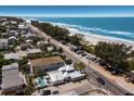 Breathtaking aerial view of coastal property featuring a pool, close beach access and stunning ocean views at 601 Gulf S Dr, Bradenton Beach, FL 34217