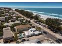 Breathtaking aerial view of coastal property featuring a pool, close beach access and stunning ocean views at 601 Gulf S Dr, Bradenton Beach, FL 34217
