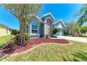View of home showing the side yard, front entrance, and large window at 6106 New Paris Way, Ellenton, FL 34222