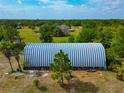 Quonset hut surrounded by mature trees offers plenty of dry storage space at 6321 279Th E St, Myakka City, FL 34251